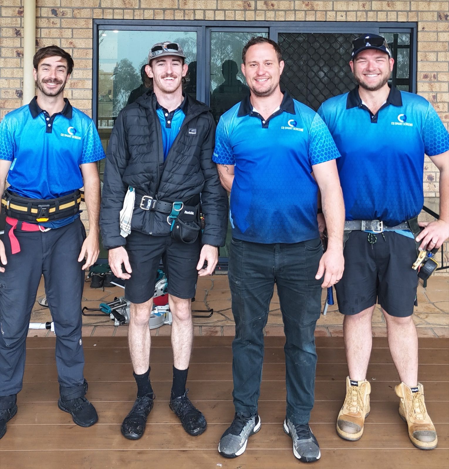 The CQ Smart Screens team of four in branded blue polo shirts